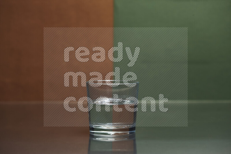 The image features a clear glassware filled with water, set against brown and dark green background