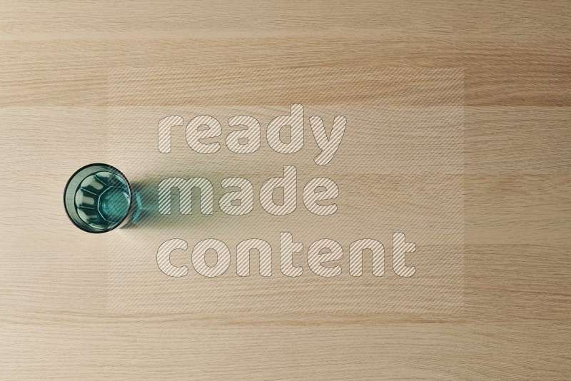 Top View Shot Of A Turquoise Glass on Oak Wooden Flooring