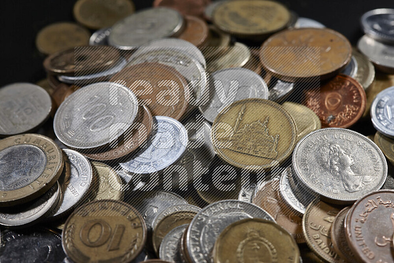 A close-ups of random old coins on black background