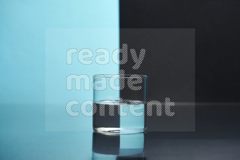 The image features a clear glassware filled with water, set against light blue and black background