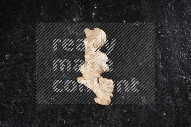Fresh ginger root on black background