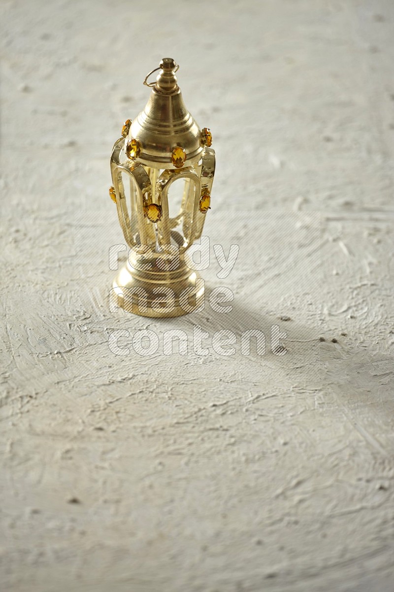A lantern placed on a textured white background