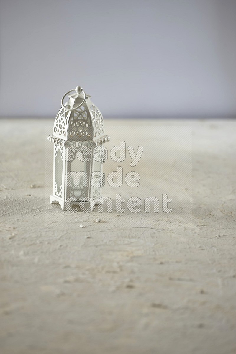 A lantern placed on a textured white background