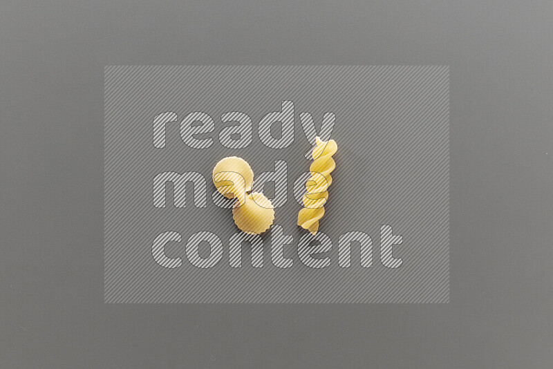 Fiocchi pasta with other types of pasta on grey background