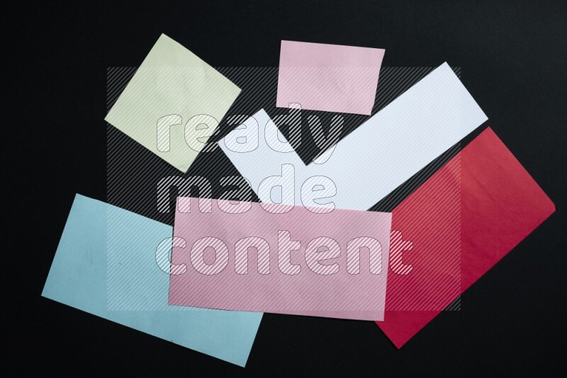 Multicolored paper sheet on black background