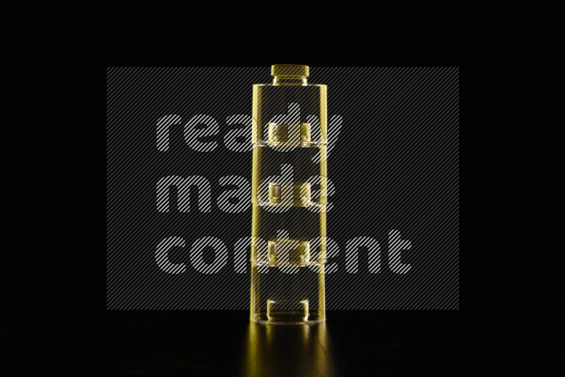 Glassware with rim light in yellow against black background