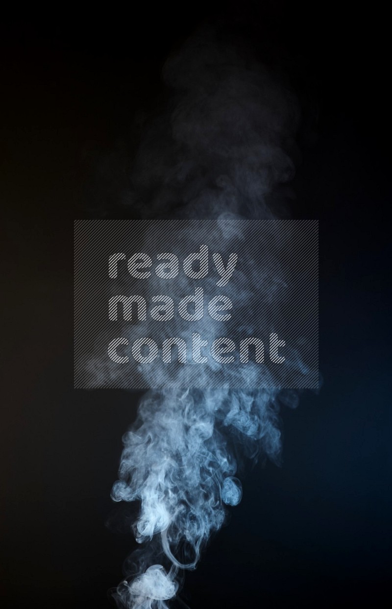 Heavy smoke in blue and yellow isolated on black background