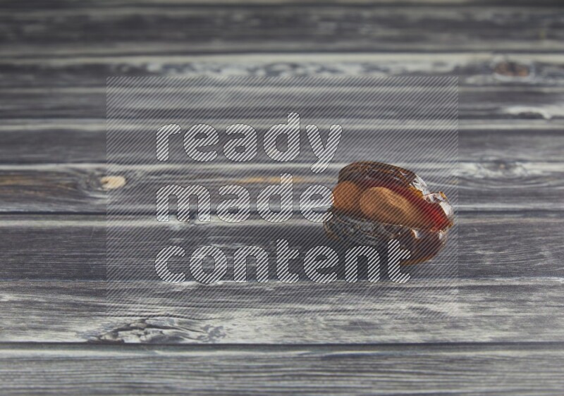 almond stuffed madjoul date on a wooden grey background