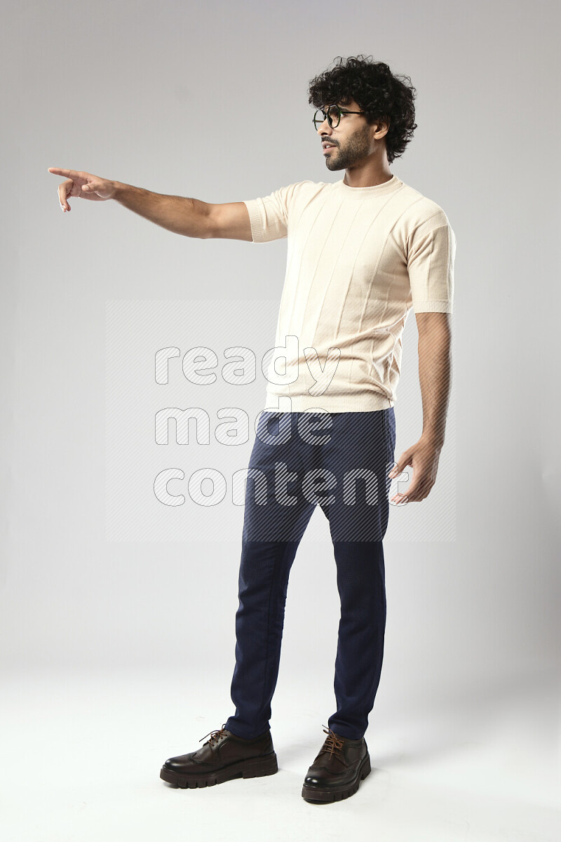 A man wearing casual standing and making a hand gesture on white background