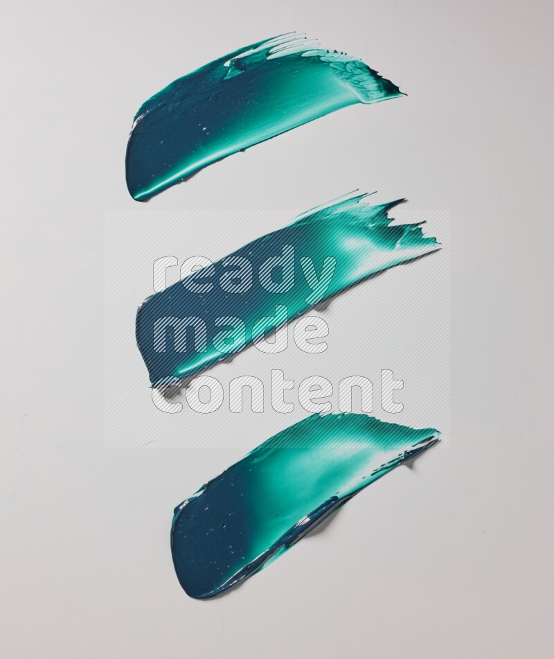 Turquoise painting knife strokes on white background