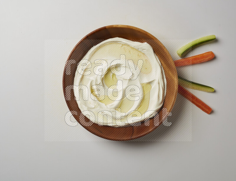 Lebnah garnished with olive oil in a wooden plate on a white background