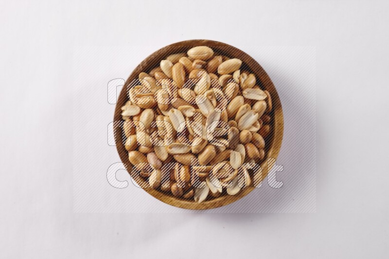 Peanuts in a wooden bowl on white background