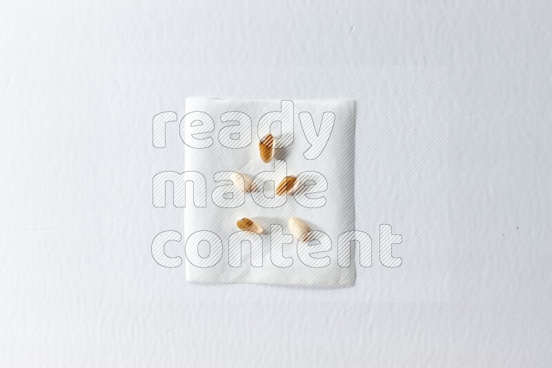 Pistachio peels on a piece of paper on a white background in different angles