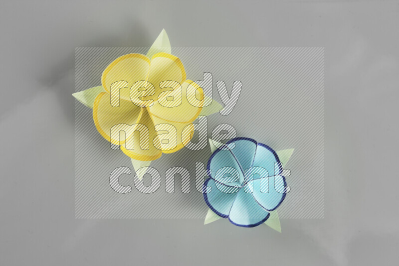 Origami flower on grey background