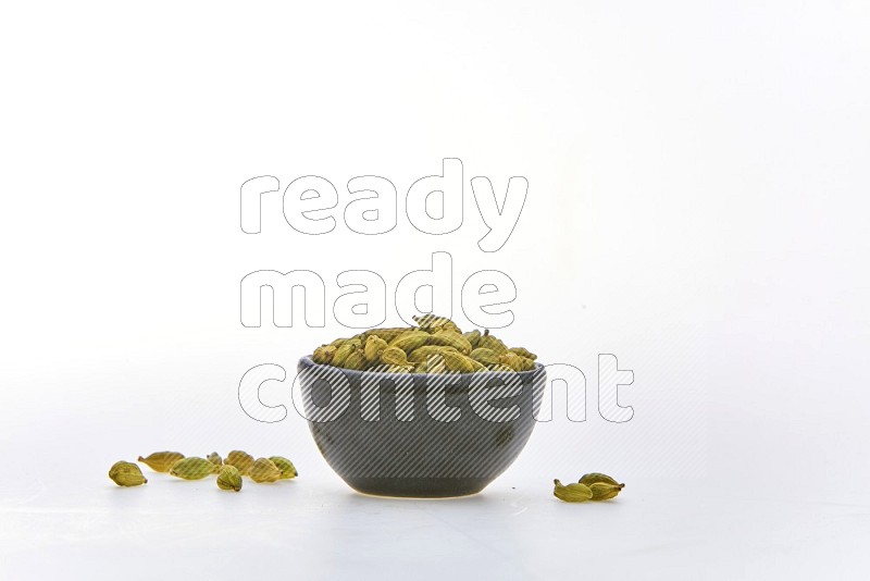 Cardamon in a container on white background