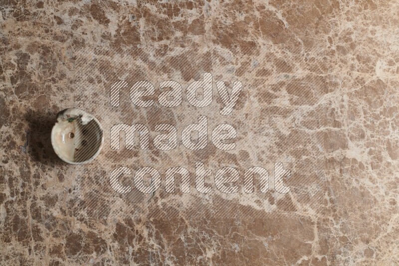 A pottery soap holder on beige marble background