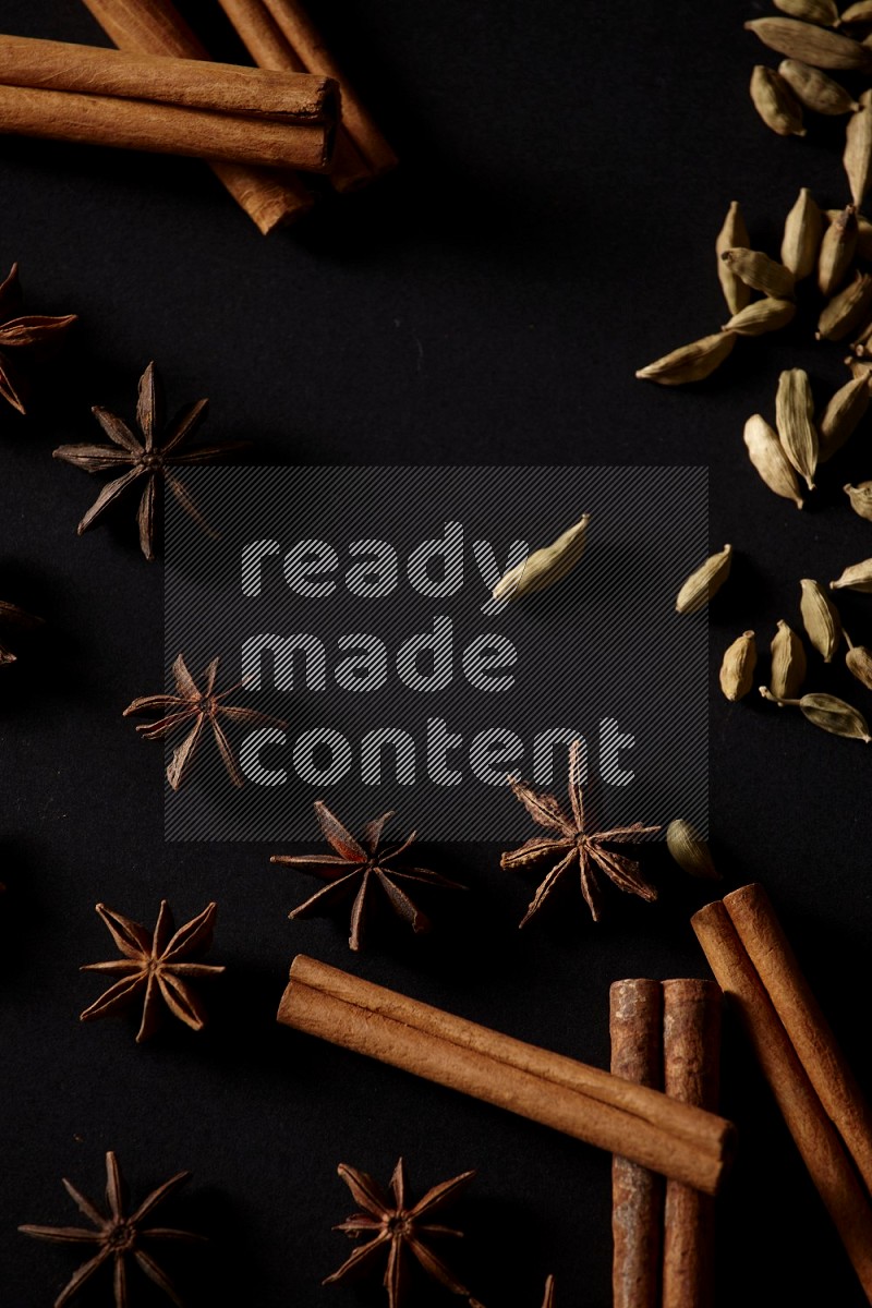 Cinnamon Sticks, Cardamom and star anise on a black background