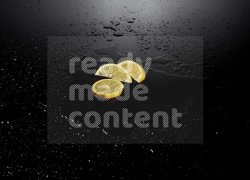 Lemon slices with water drops, and droplets on black background