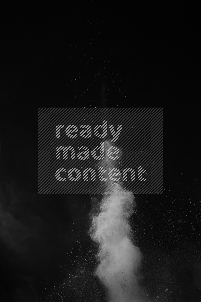 A side view of white powder explosion on black background