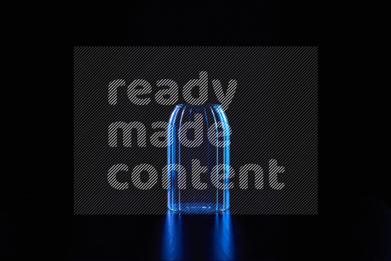 Glassware with rim light in blue against black background