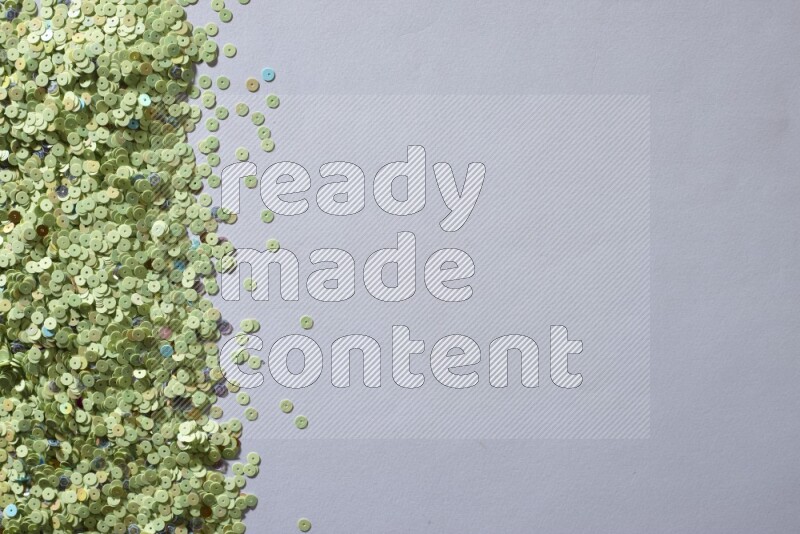 Multicolored flat sequins on grey background