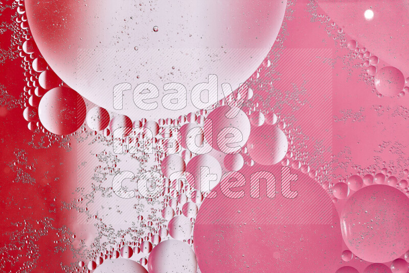 Close-ups of abstract oil bubbles on water surface in shades of white, red and pink