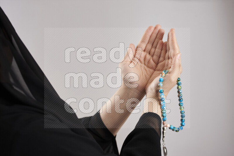 Woman hands holding praying beads (sebha) in different positions