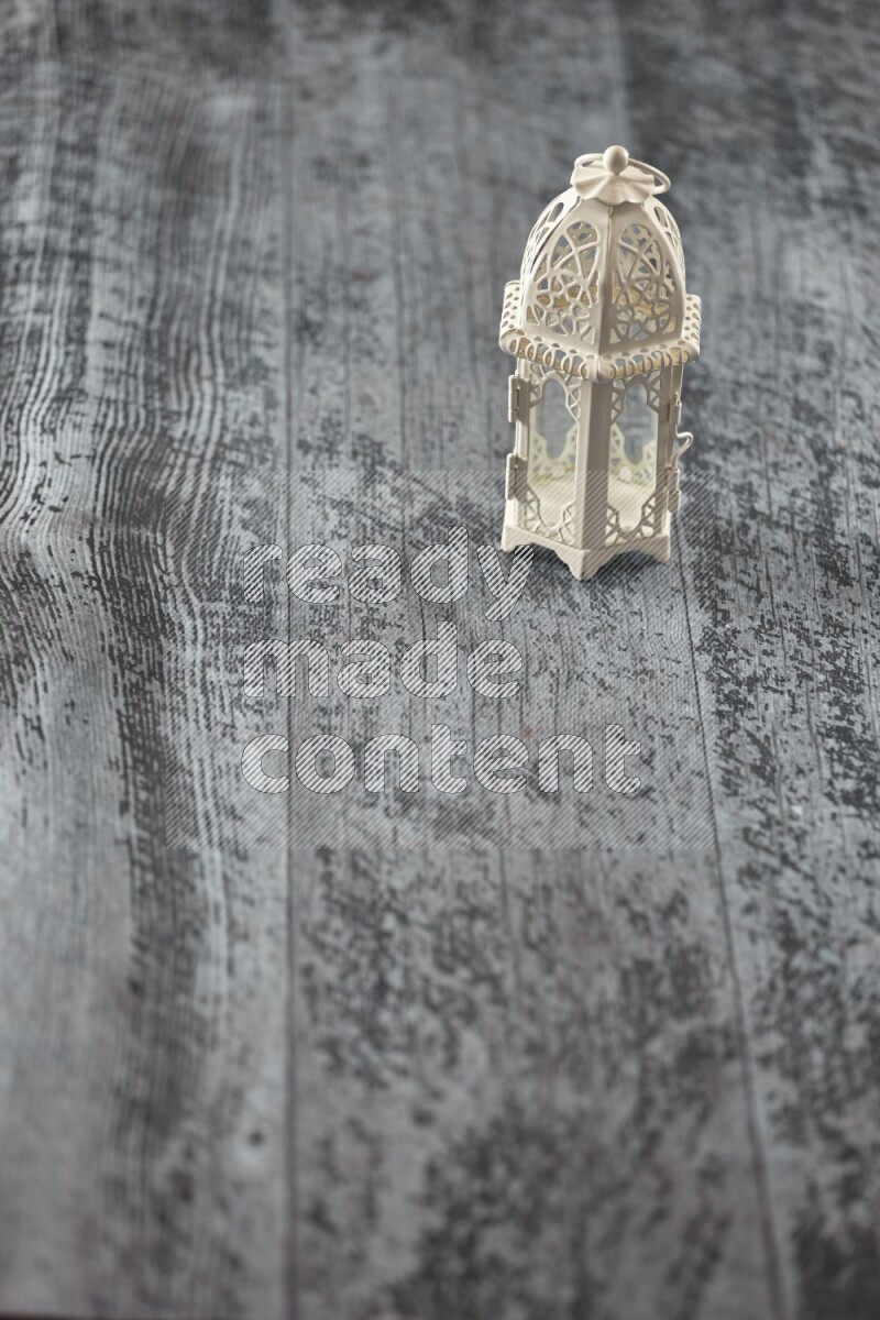 A lantern placed on a wooden background