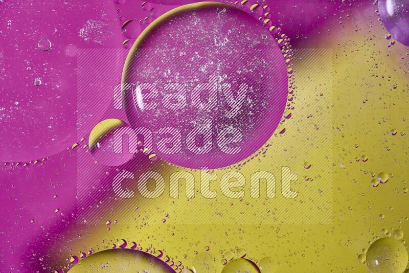 Close-ups of abstract oil bubbles on water surface in shades of yellow and pink