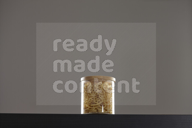 Snacks in a glass jar on black background