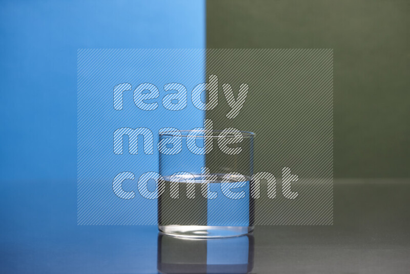 The image features a clear glassware filled with water, set against blue and dark green background