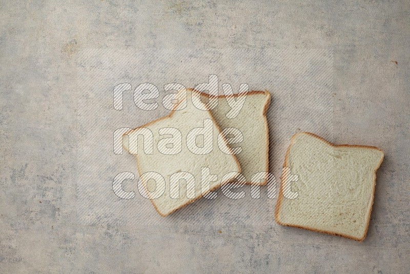 White Toast slices on alight blue textured background