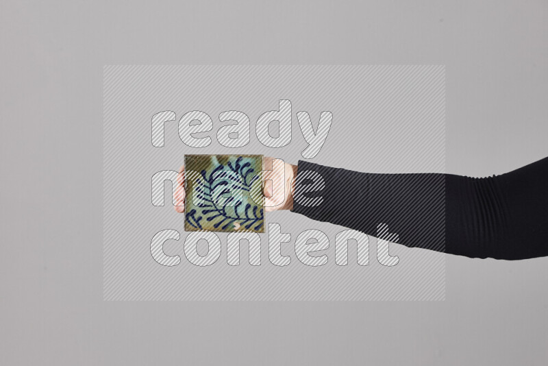 A woman in black abaya holding different pottery essentials in different positions