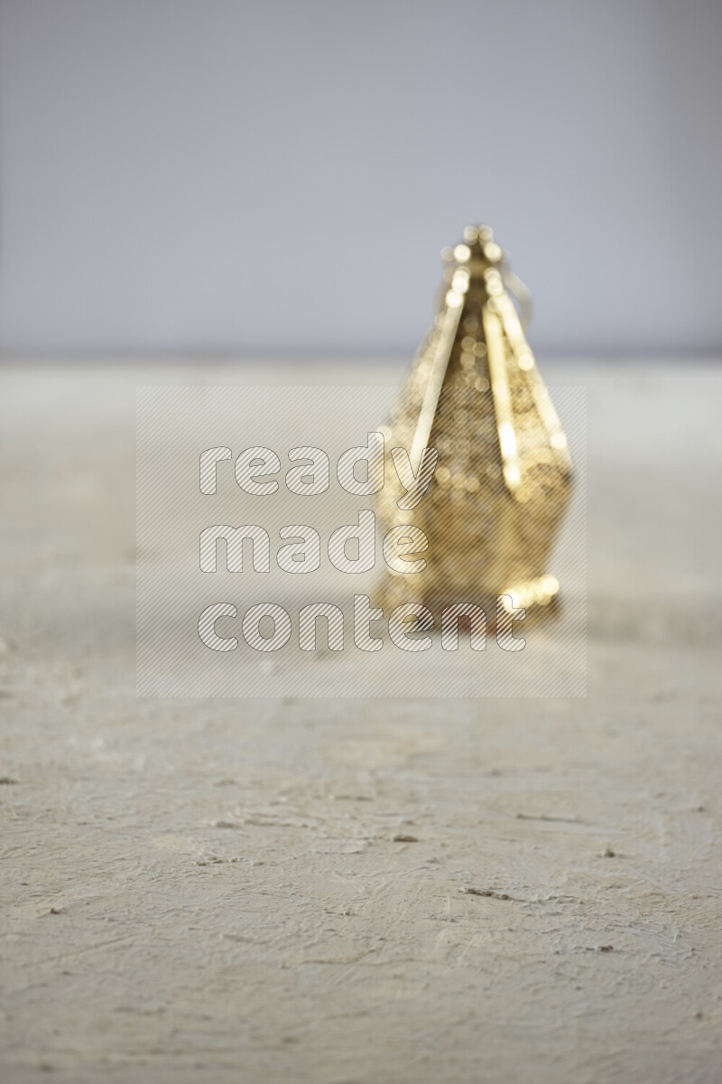 A lantern placed on a textured white background