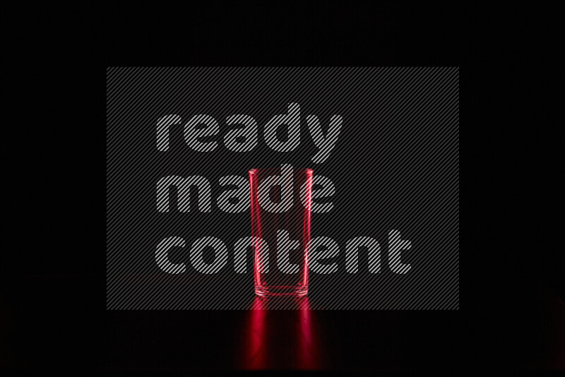 Glassware with rim light in red against black background