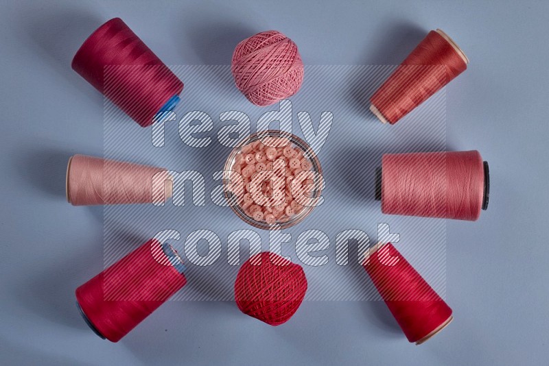 Pink sewing supplies on blue background