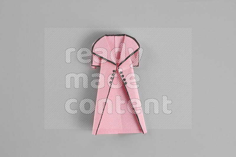 Origami clothes on grey background