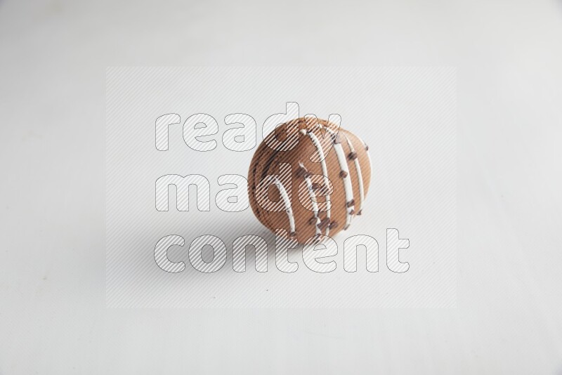 45º Shot of Brown white Chocolate Caramel macaron on white background