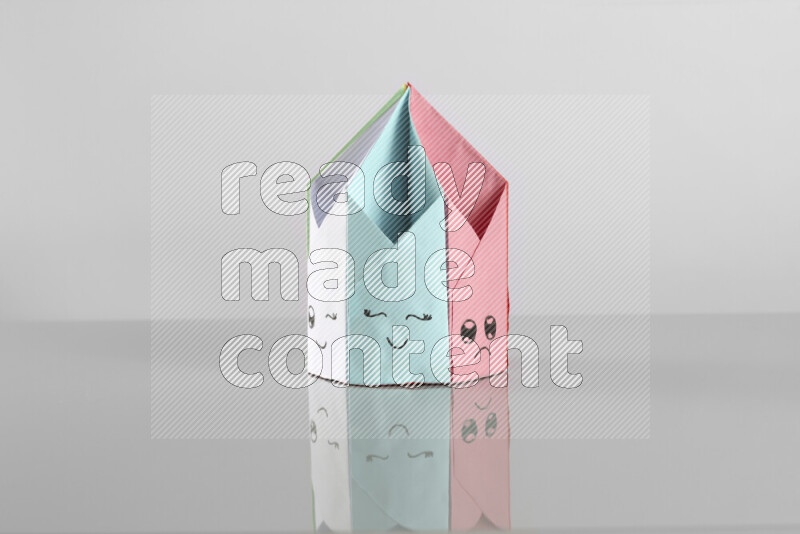Origami pen holder on grey background