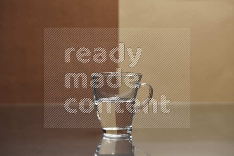 The image features a clear glassware filled with water, set against brown and beige background