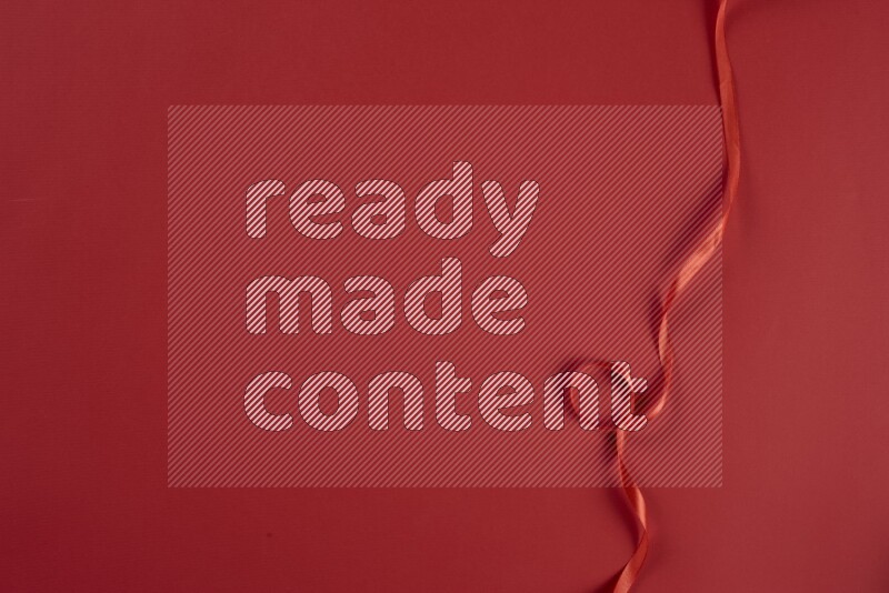 مجموعة من أدوات الخياطة والتفصيل حمراء اللون على خلفية حمراء