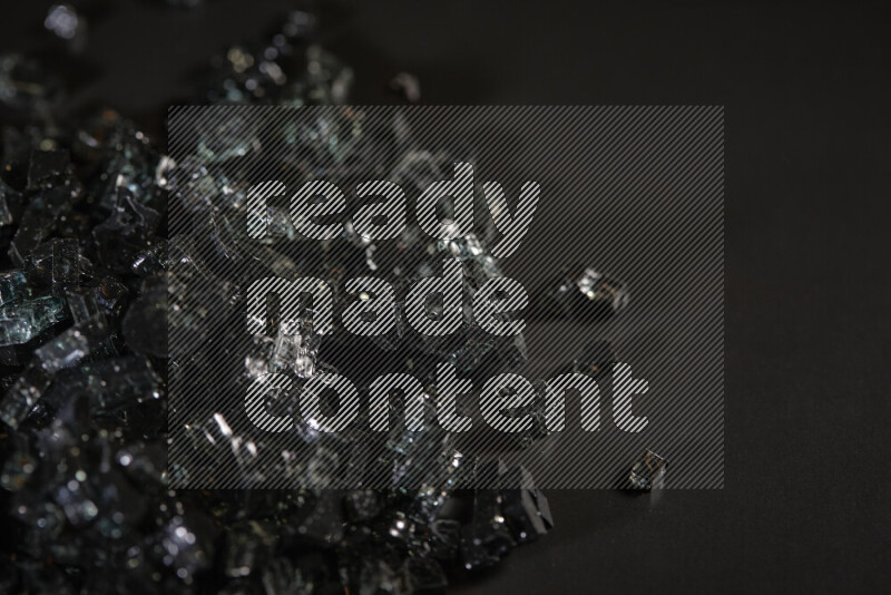 قطع زجاج سوداء شفافة متناثرة على خلفية سوداء