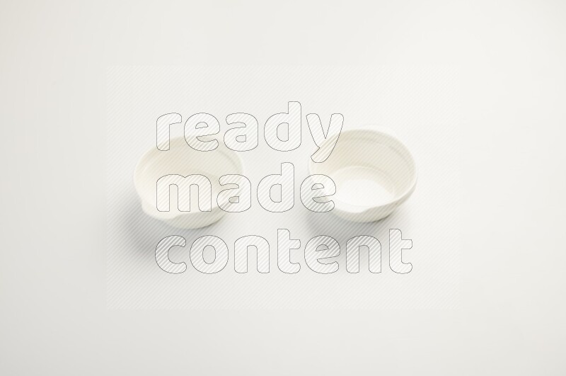 white ceramic round sauce dish on white countertop