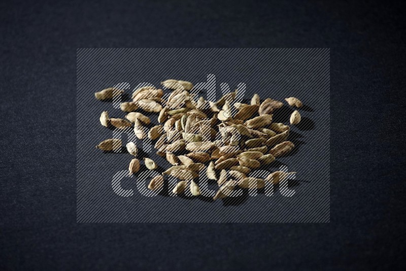Cardamom seeds on black flooring