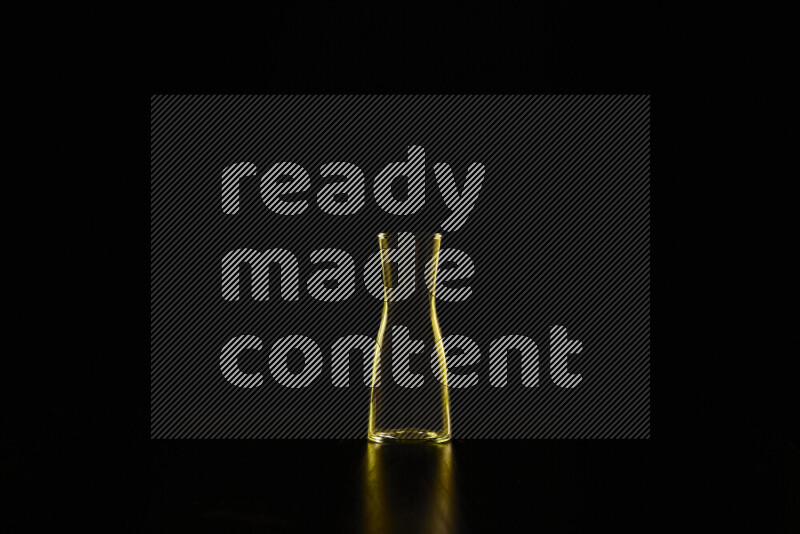 Glassware with rim light in yellow against black background