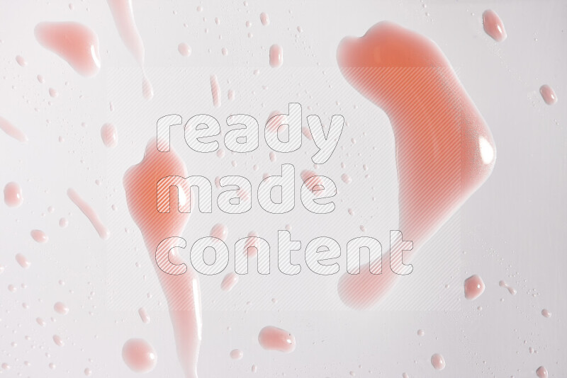 Close-ups of abstract red paint droplets on white background