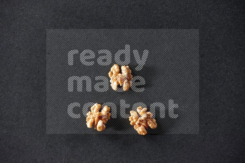 3 walnuts on a black background in different angles