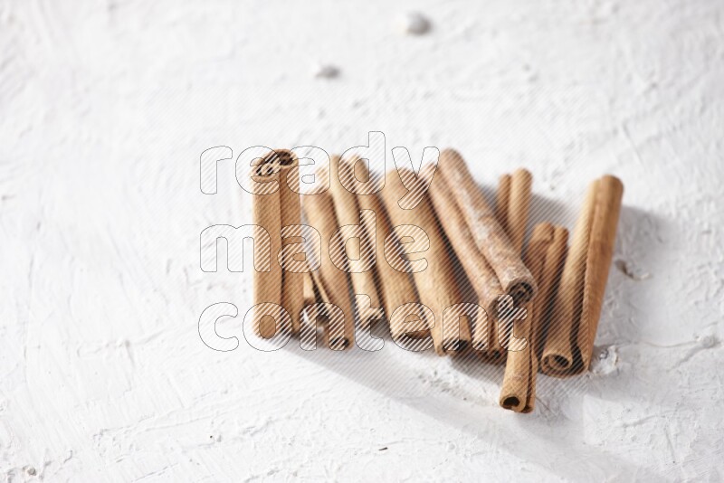 Cinnamon sticks on a textured white background
