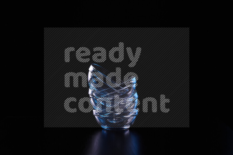 Glassware with rim light in blue and white against black background