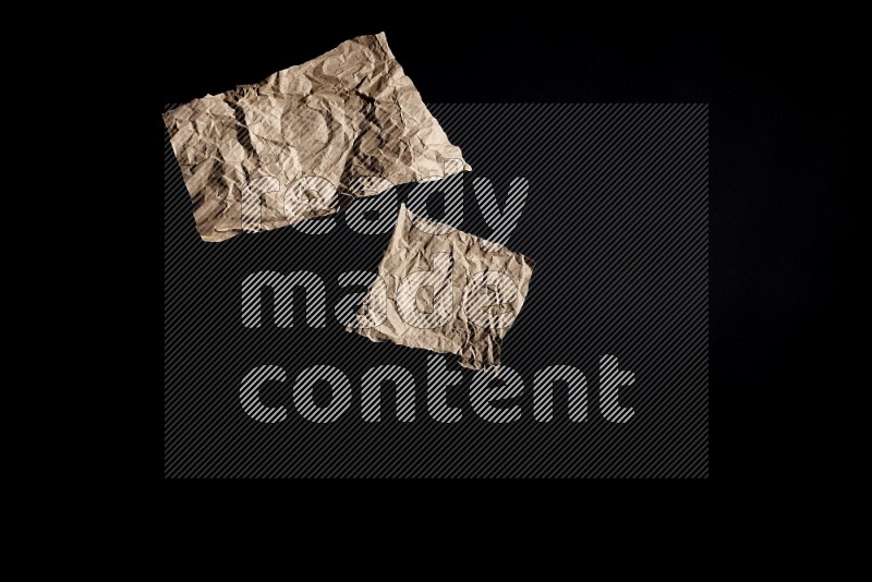 Crumpled craft paper on black background